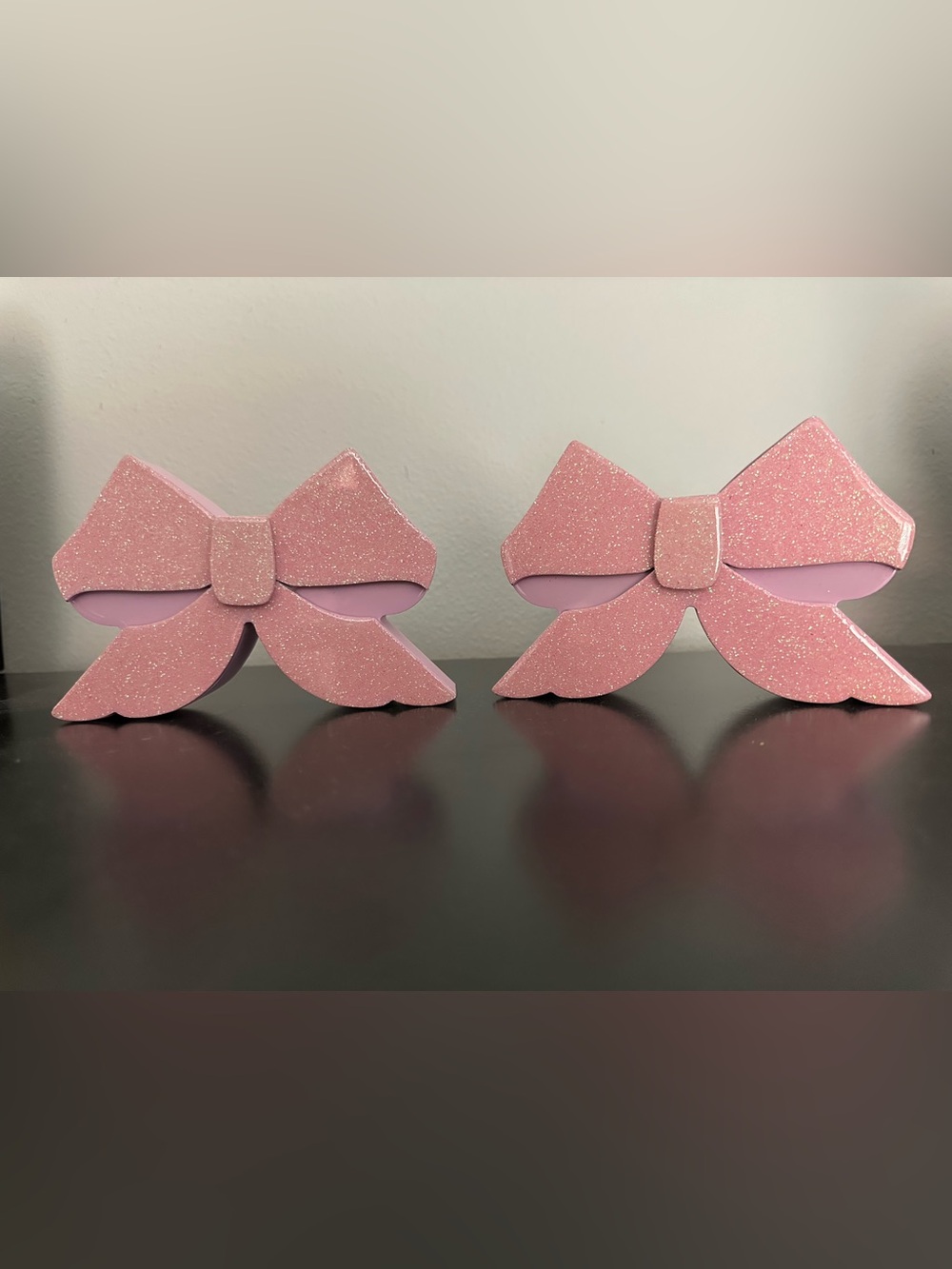 Pink and sparkles bow home decor.  Made of wood with resin pink sparkly overlay